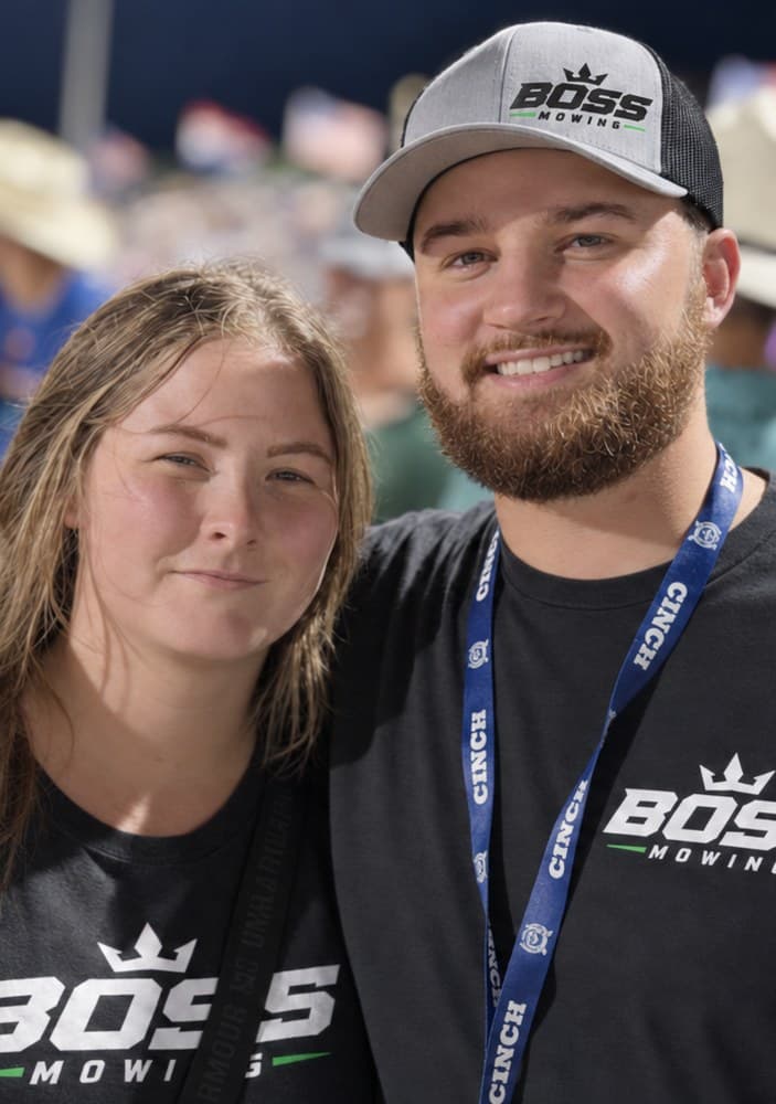Zandier Ashley and his wife, owners of Boss Mowing, in Boss Mowing shirts